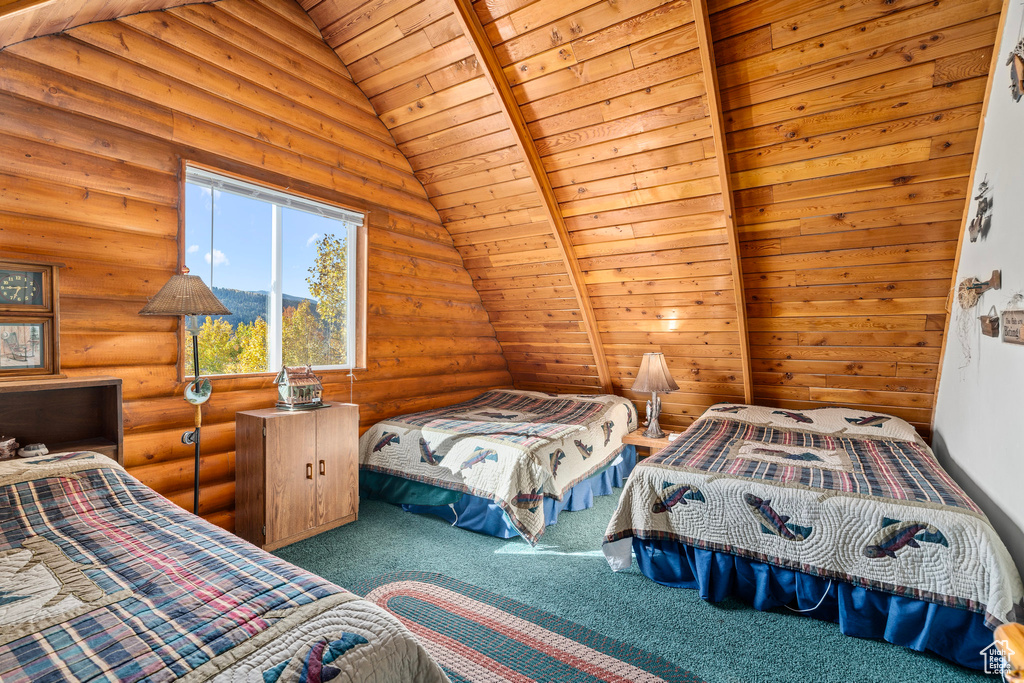 Carpeted bedroom with rustic walls, vaulted ceiling, and wood ceiling