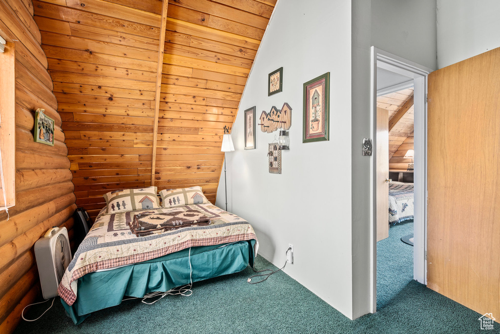 Carpeted bedroom with lofted ceiling, rustic walls, and wooden ceiling
