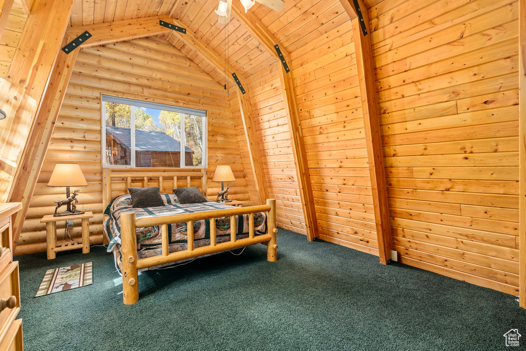 Carpeted bedroom featuring rustic walls and wooden ceiling