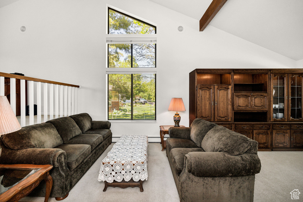 Living room featuring light carpet, high vaulted ceiling, beam ceiling, and a baseboard radiator