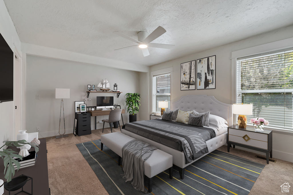 Bedroom with carpet flooring, a desk, a textured ceiling, baseboards, and a ceiling fan