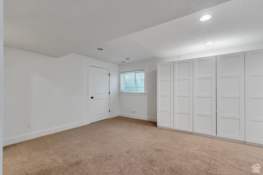 Unfurnished bedroom featuring carpet floors, baseboards, recessed lighting, and a textured ceiling