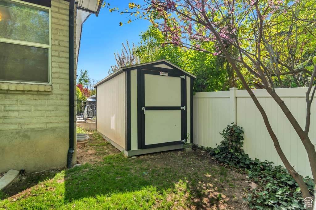 View of shed featuring fence