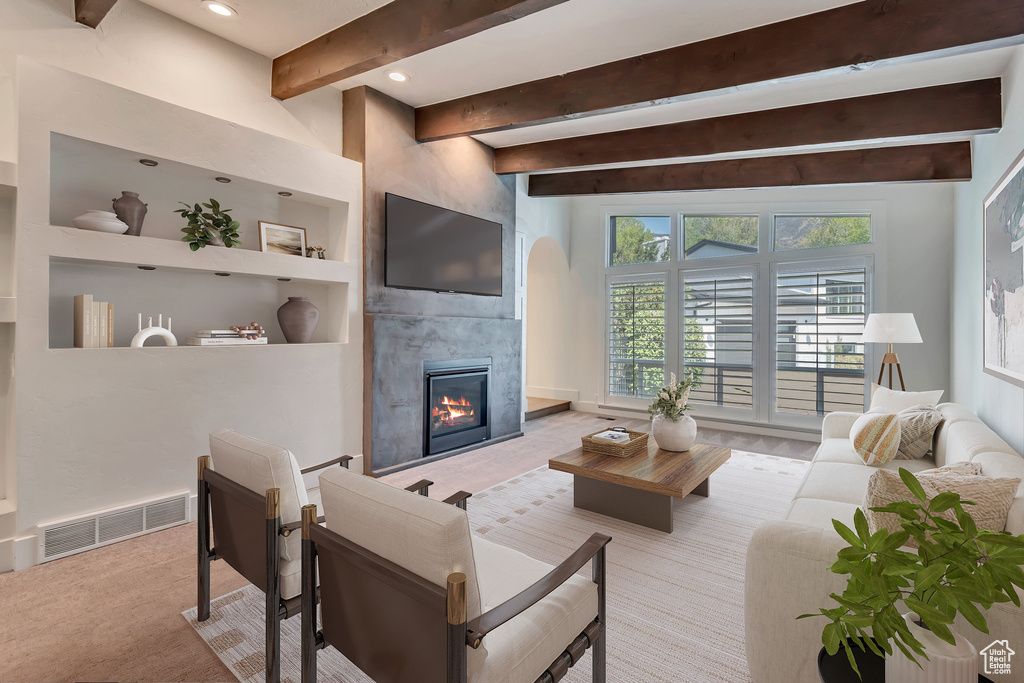 Living room with beam ceiling, a fireplace, recessed lighting, and carpet floors