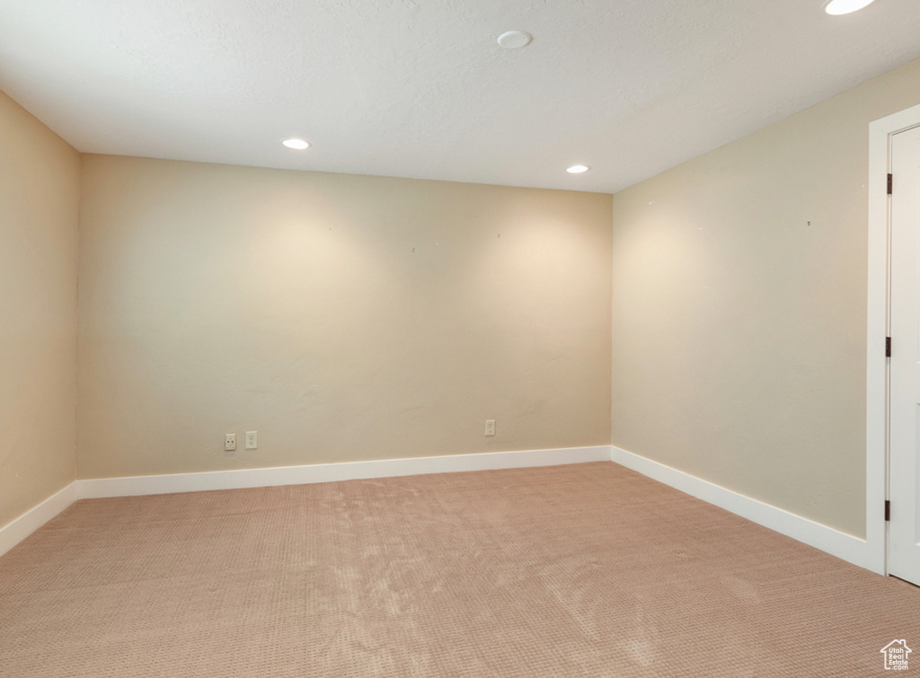 Empty room featuring light colored carpet, recessed lighting, and baseboards