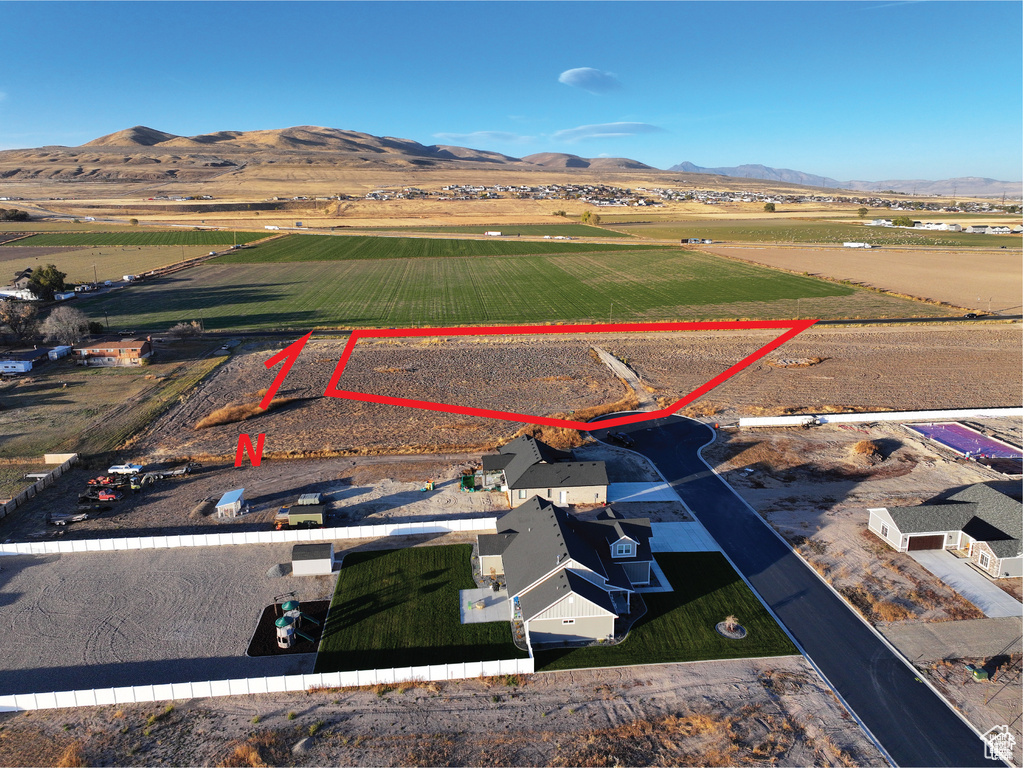 Aerial view of sparsely populated area featuring a mountain backdrop