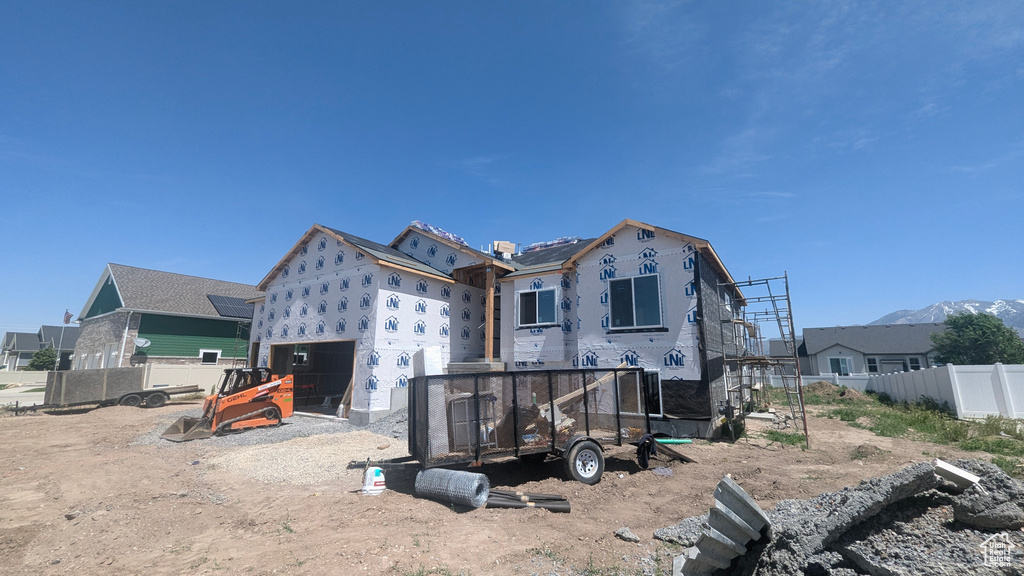 Back of property featuring fence and an attached garage
