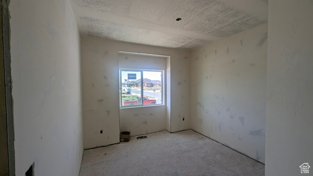 Unfurnished room with a textured ceiling