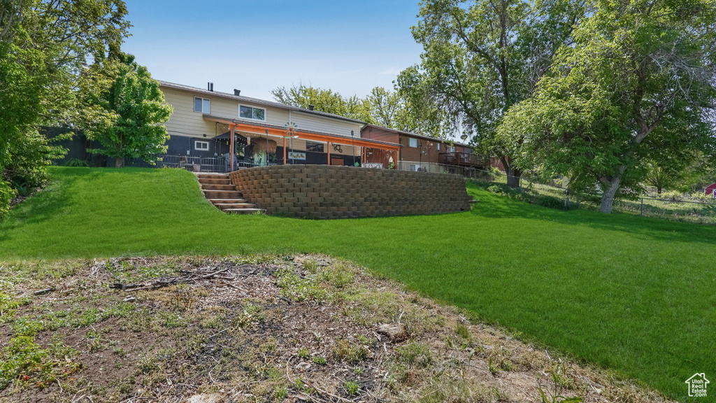 Rear view of property with stairway and a wooden deck