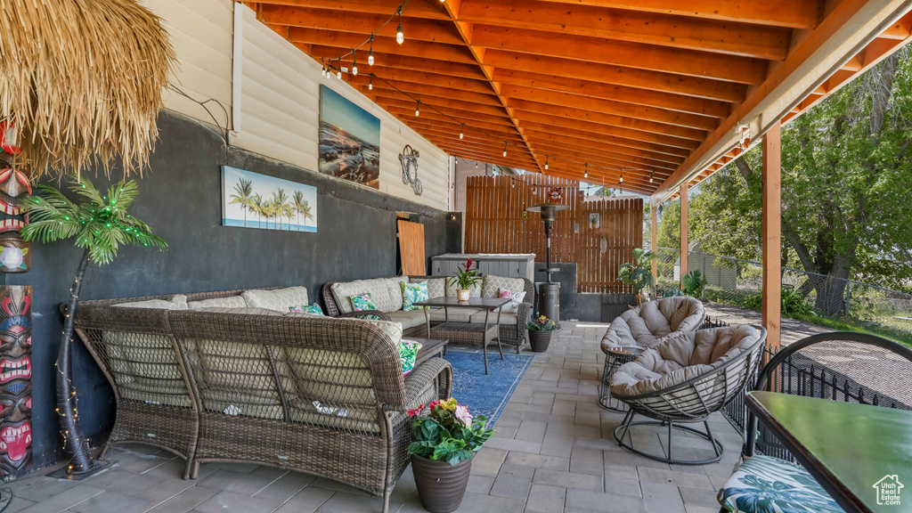 View of patio / terrace featuring an outdoor living space and fence