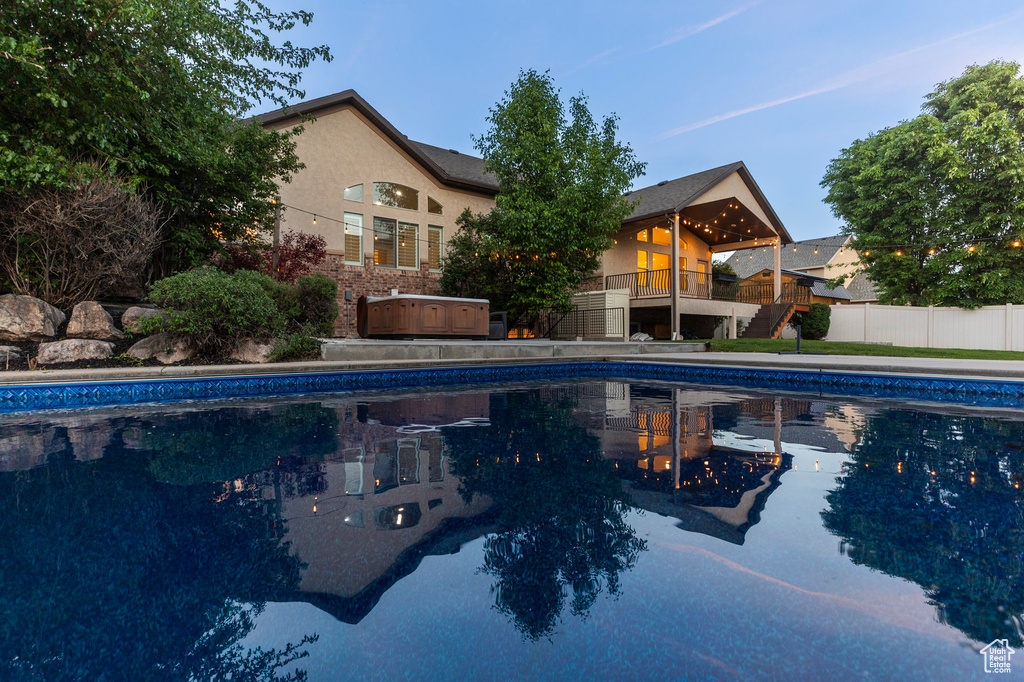 View of pool with fence and stairs