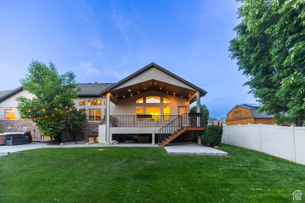 Back of house with a patio, stairs, stucco siding, and a wooden deck
