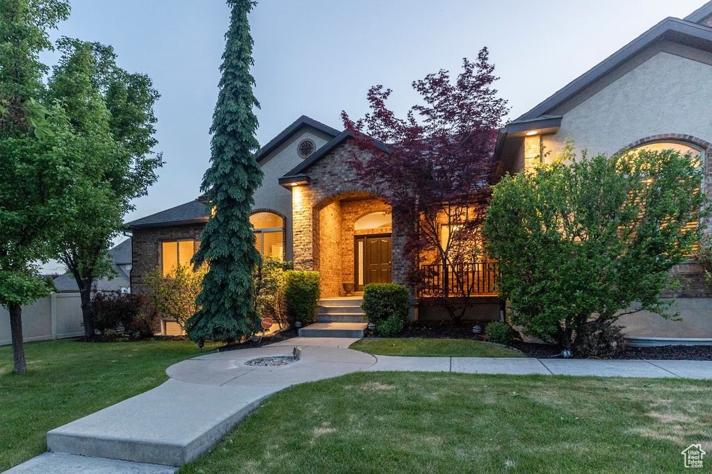 View of front of property featuring brick siding and stone siding