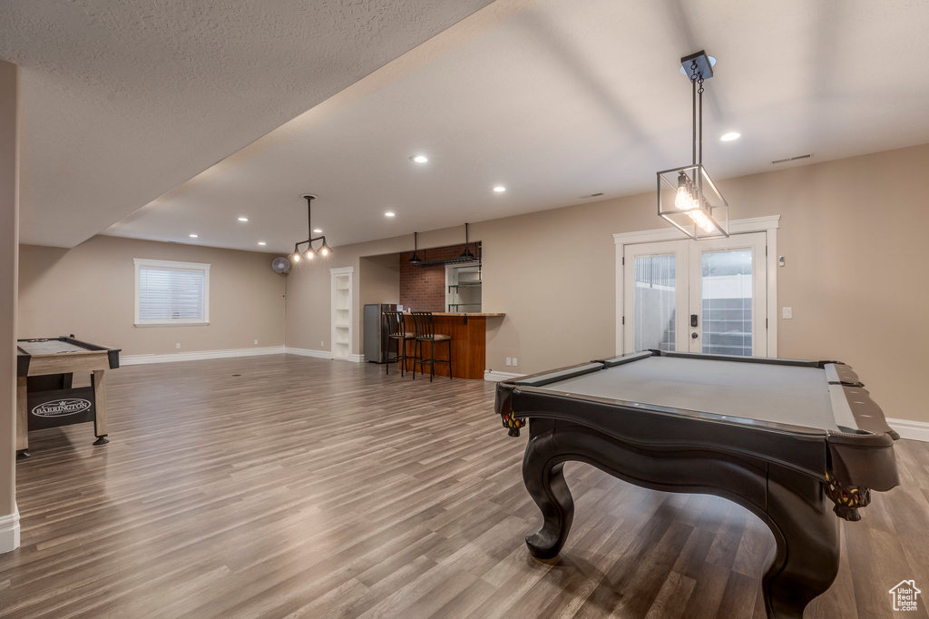 Recreation room featuring billiards, french doors, baseboards, wood finished floors, and recessed lighting