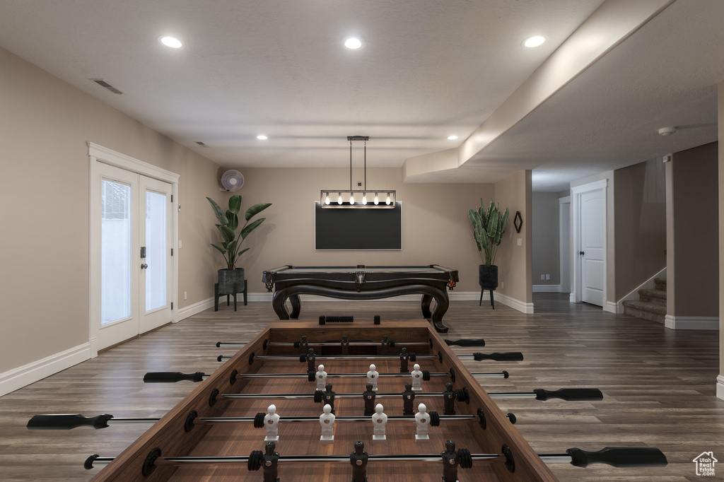 Recreation room featuring wood finished floors, recessed lighting, baseboards, and french doors