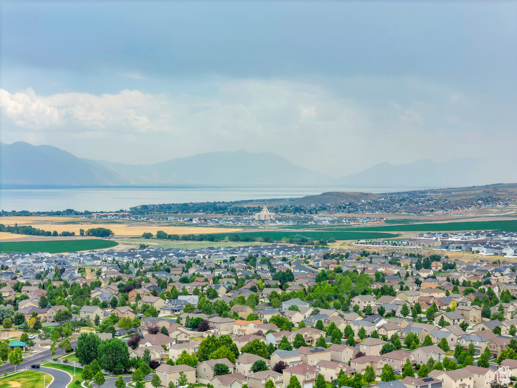 Aerial view of residential area featuring a water and mountain view