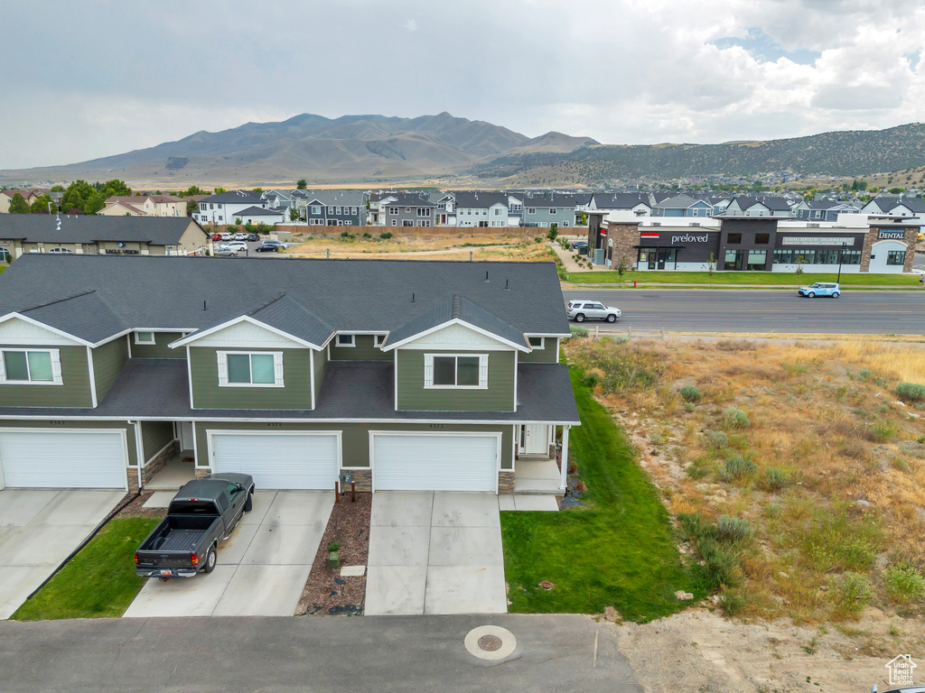 View of front facade with a residential view, a mountain view, and a garage