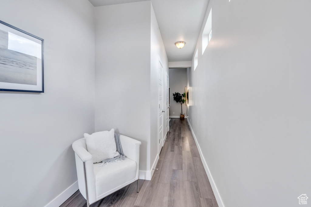 Hall featuring wood finished floors and baseboards