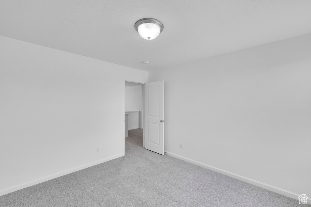 Carpeted spare room with baseboards