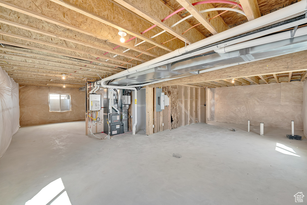 Basement with electric panel and heating unit
