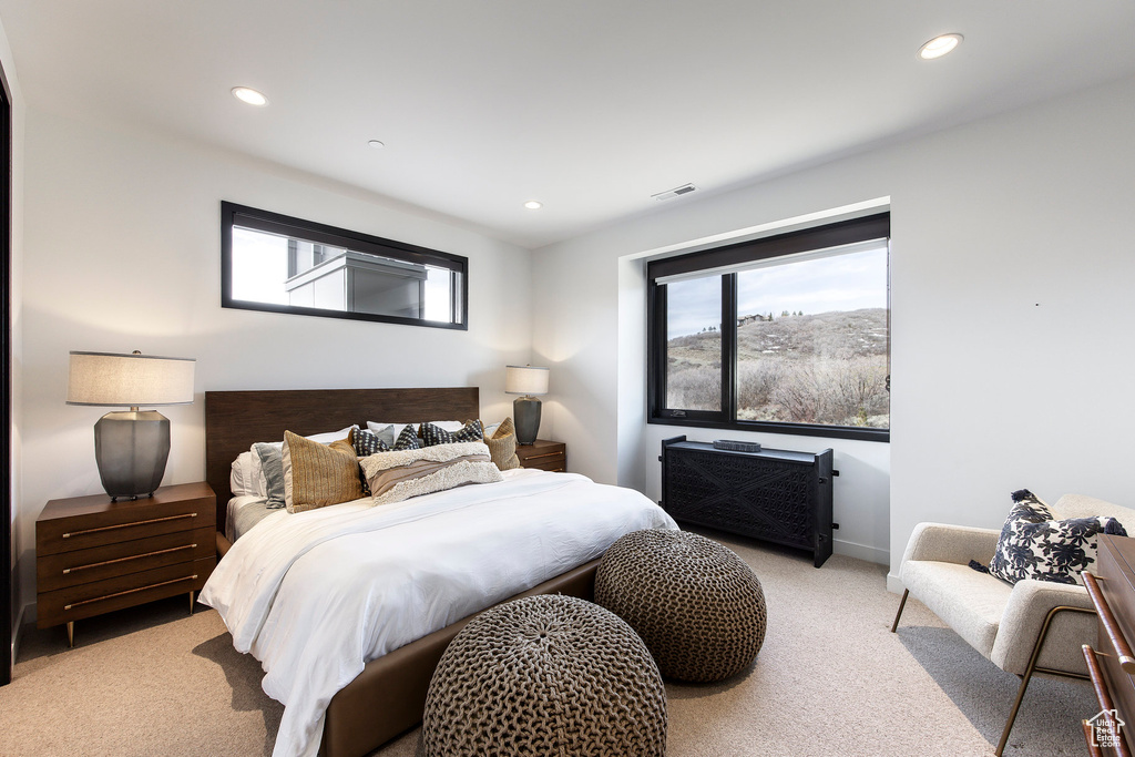 Bedroom with light carpet, recessed lighting, and baseboards
