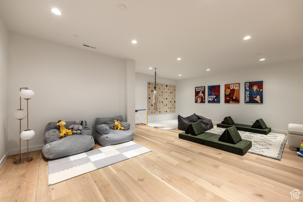 Living room featuring wood finished floors, baseboards, and recessed lighting