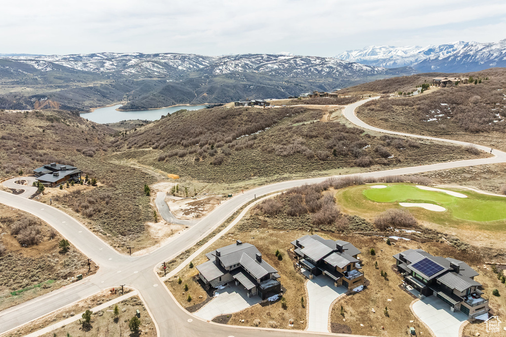 Aerial view of property and surrounding area with a water and mountain view