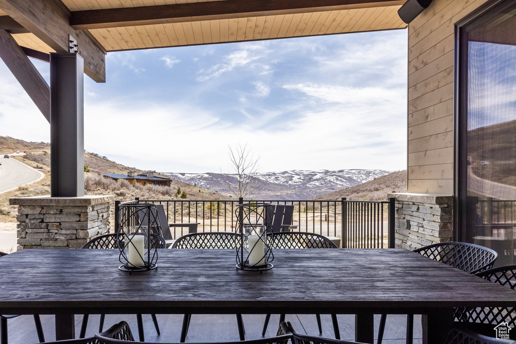 Balcony with outdoor dining area and a mountain view