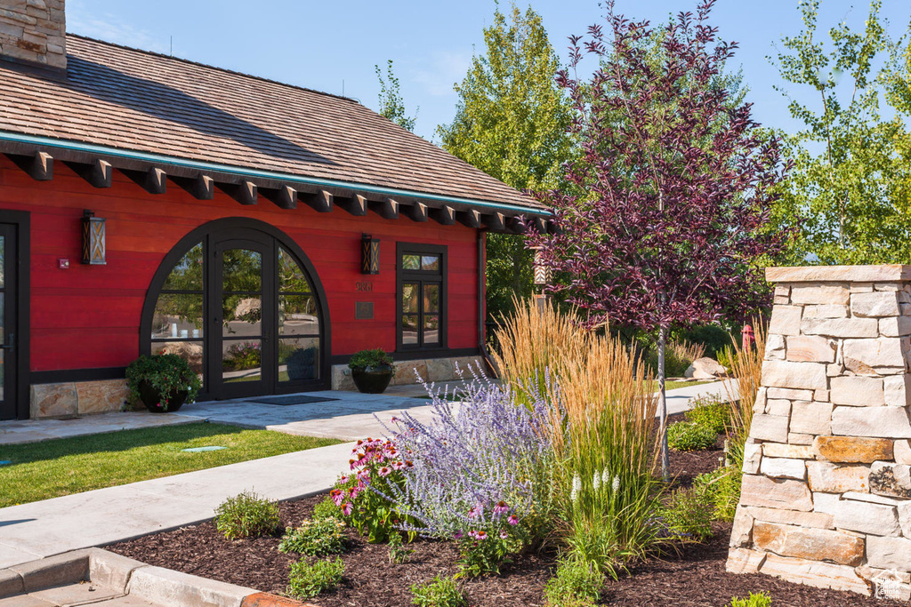 View of exterior entry featuring french doors and a chimney
