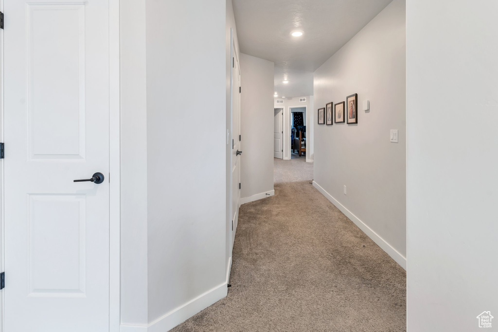 Hall featuring carpet, baseboards, and recessed lighting