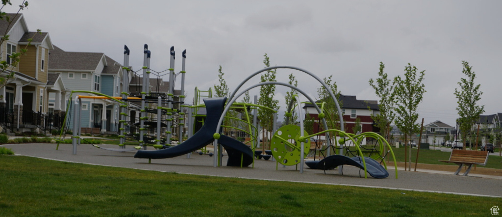 Community playground featuring a residential view and a lawn