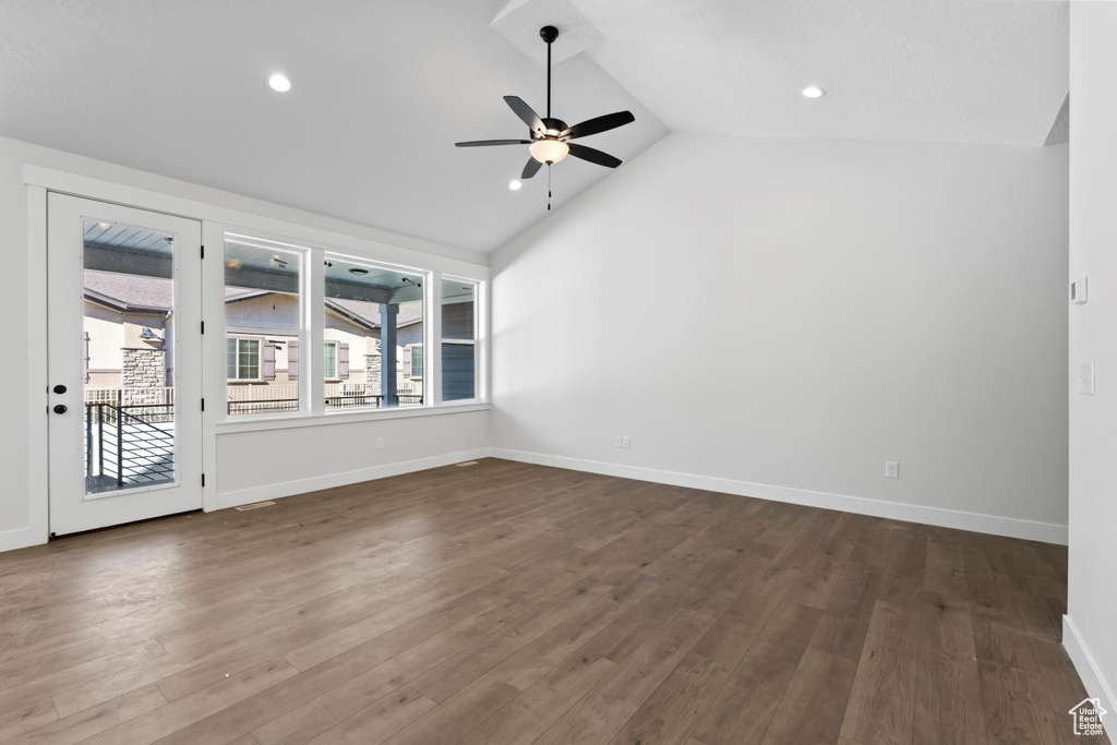 Empty room featuring ceiling fan, vaulted ceiling, dark wood finished floors, recessed lighting, and baseboards