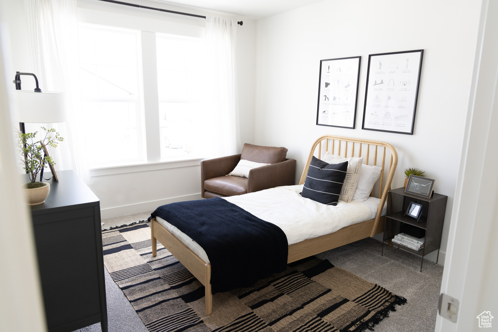 Carpeted bedroom featuring baseboards