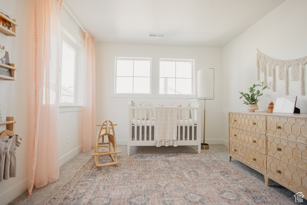 Carpeted bedroom featuring baseboards