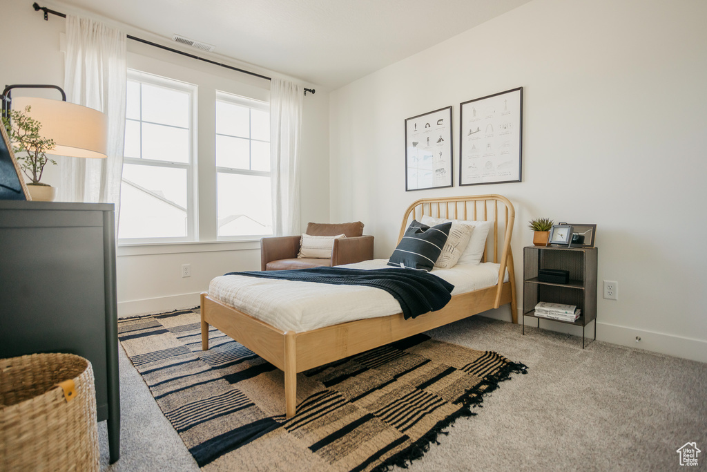 Bedroom featuring carpet flooring and baseboards