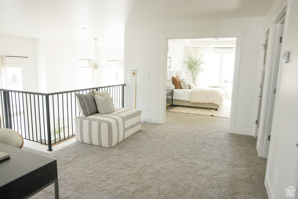 Hallway with carpet floors and baseboards