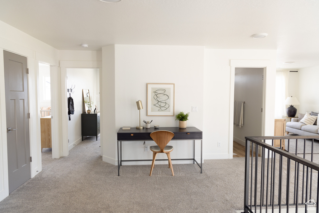 Hall featuring carpet flooring and baseboards