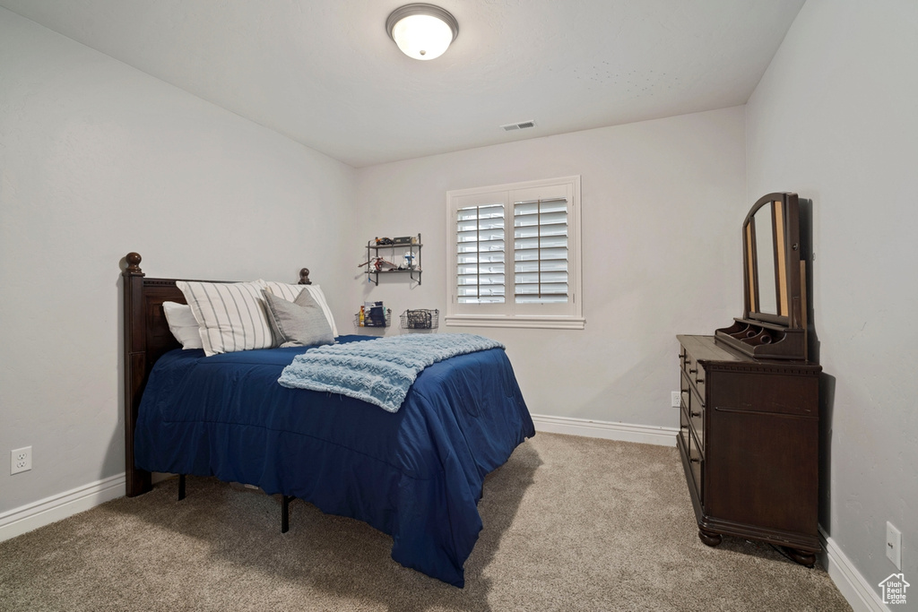 Carpeted bedroom with baseboards