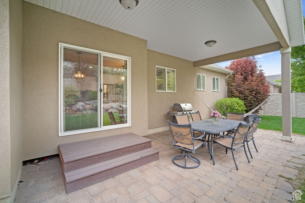 View of patio with outdoor dining space and fence
