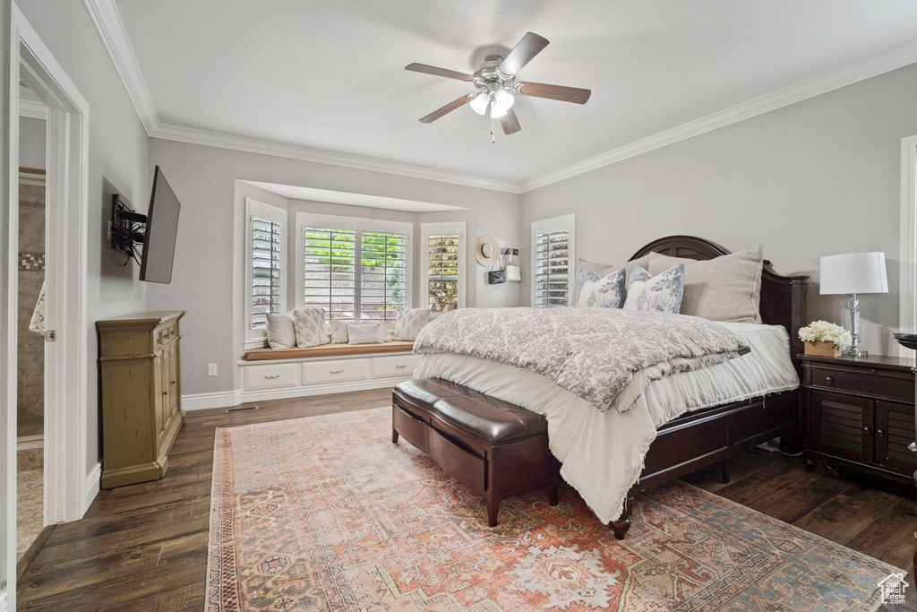 Bedroom with crown molding, dark wood-style flooring, baseboards, and ceiling fan