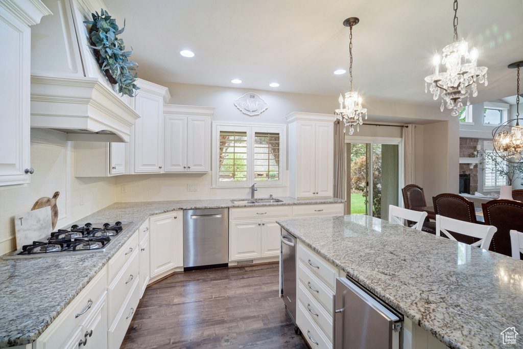 Kitchen with a chandelier, appliances with stainless steel finishes, a sink, recessed lighting, and plenty of natural light