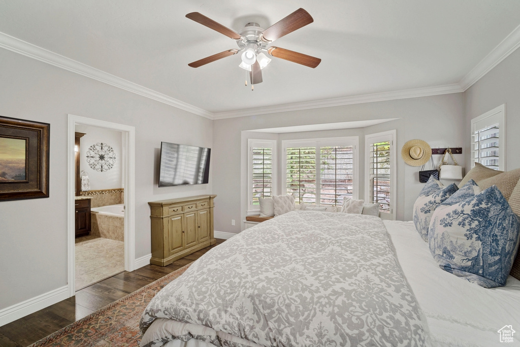 Bedroom with dark wood-style floors, crown molding, baseboards, a ceiling fan, and ensuite bathroom