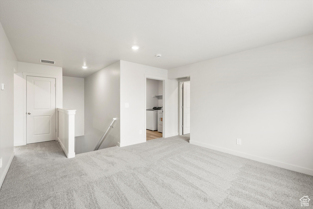 Spare room featuring carpet floors, washer / clothes dryer, and recessed lighting