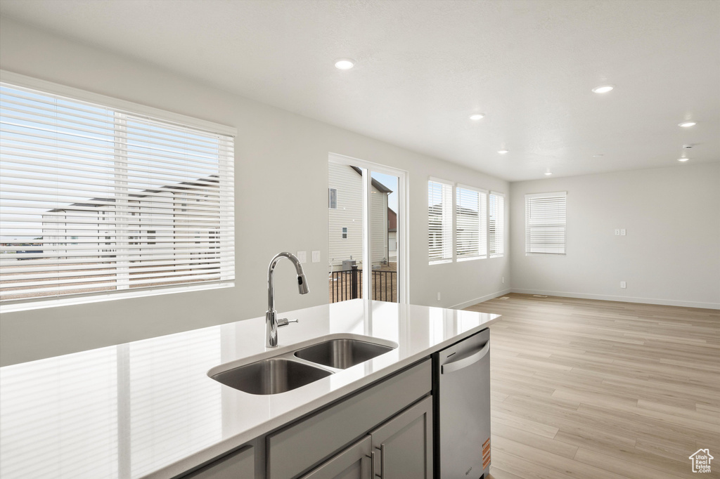 Kitchen with dishwasher, gray cabinetry, light countertops, light wood finished floors, and recessed lighting