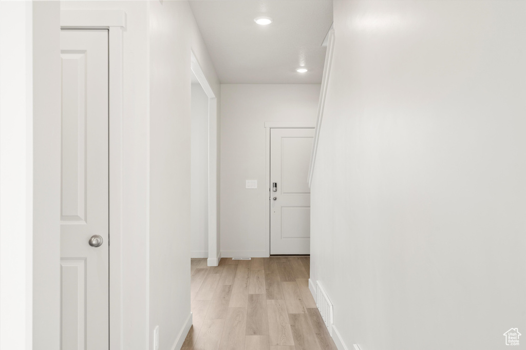 Hallway featuring light wood-type flooring and recessed lighting