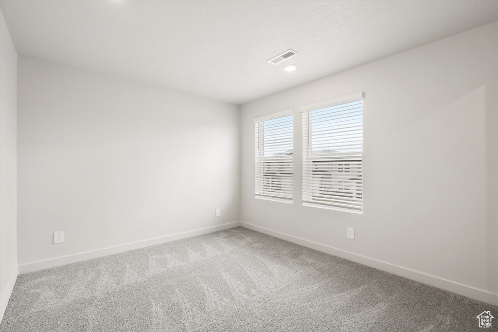 Empty room with carpet floors and recessed lighting