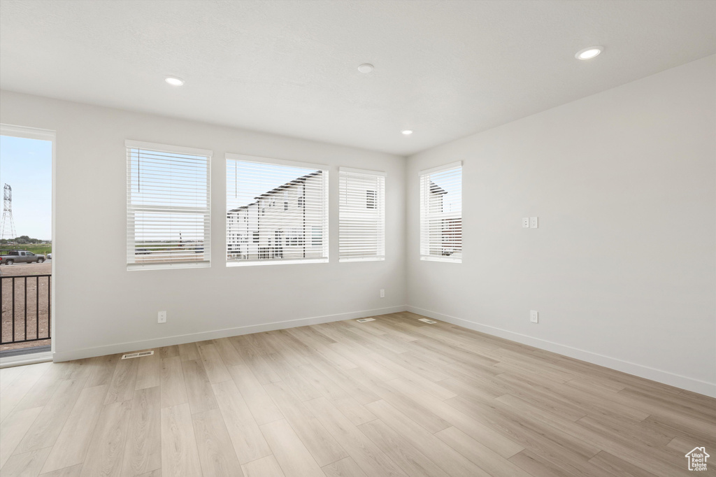 Unfurnished room with light wood-style flooring and recessed lighting