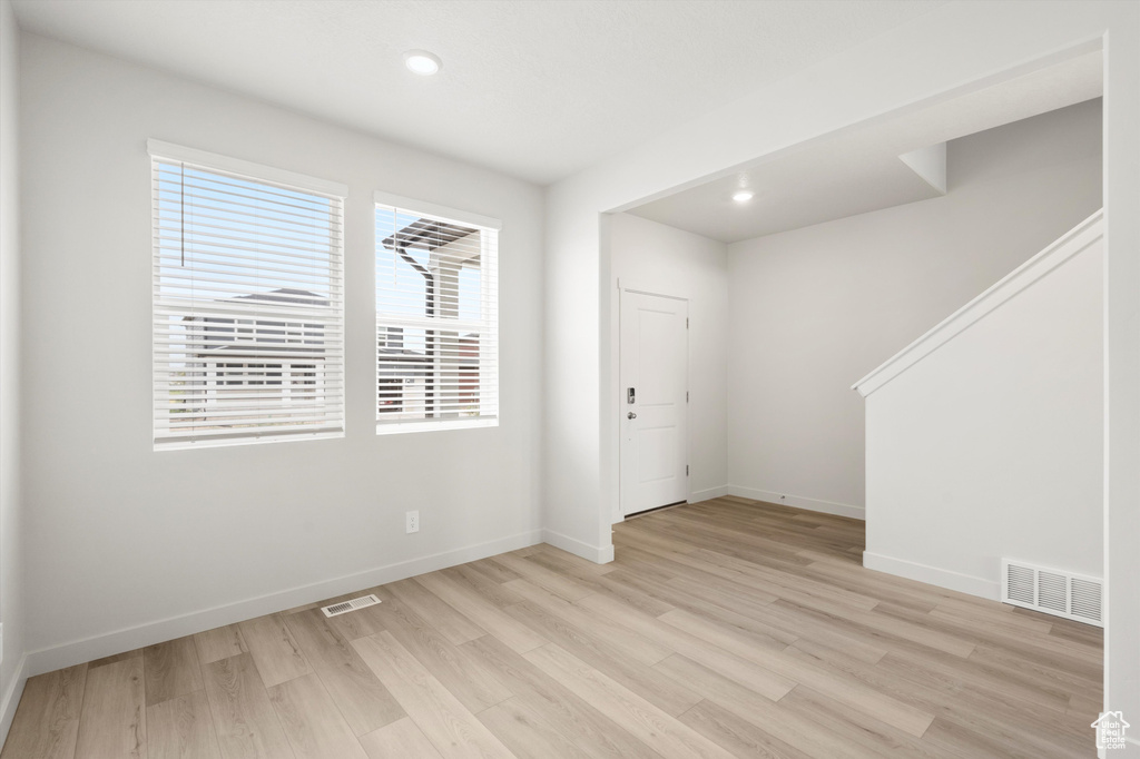 Foyer with light wood-style floors and recessed lighting