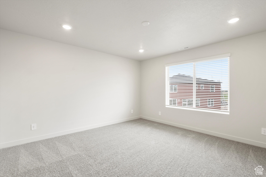 Empty room featuring carpet flooring and recessed lighting