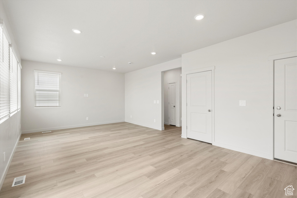 Spare room with light wood finished floors and recessed lighting